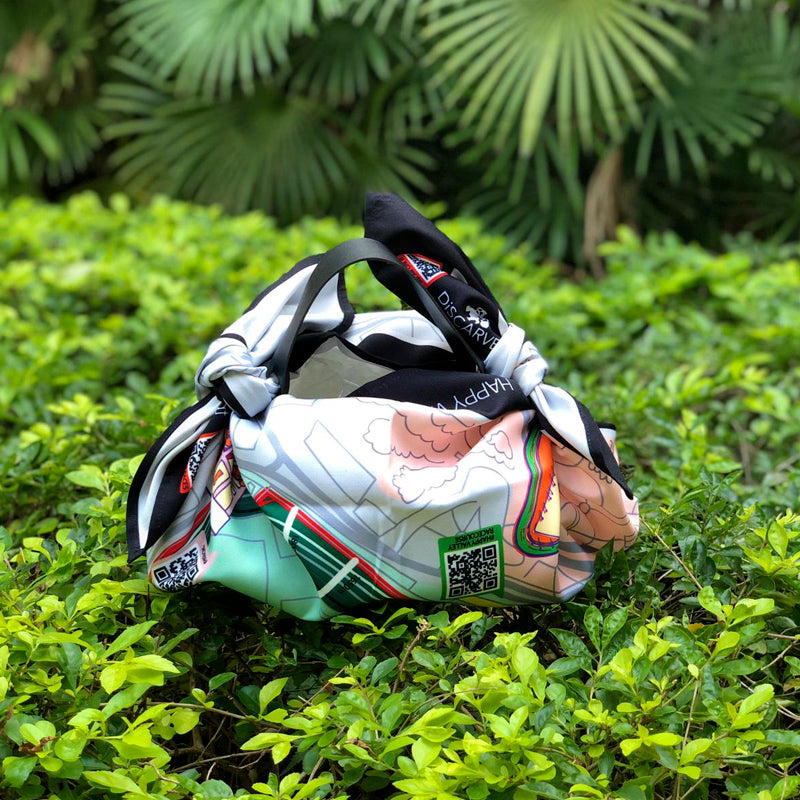 DiSCARVERY Wrap Bag X Jockey Club featuring a colorful map print, designed for eco-friendly travelers.